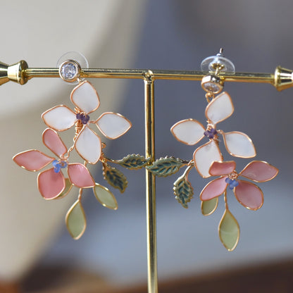 Close-up view of Candace floral resin earrings showcasing pastel petals, delicate bead accents and handcrafted gold wirework