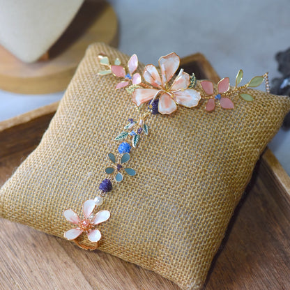 Candace handcrafted floral hand harness featuring blush pink and ivory flowers with pastel foliage and soft gold wire detailing