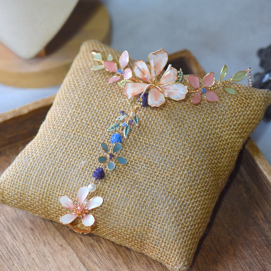 Candace handcrafted floral hand harness featuring blush pink and ivory flowers with pastel foliage and soft gold wire detailing