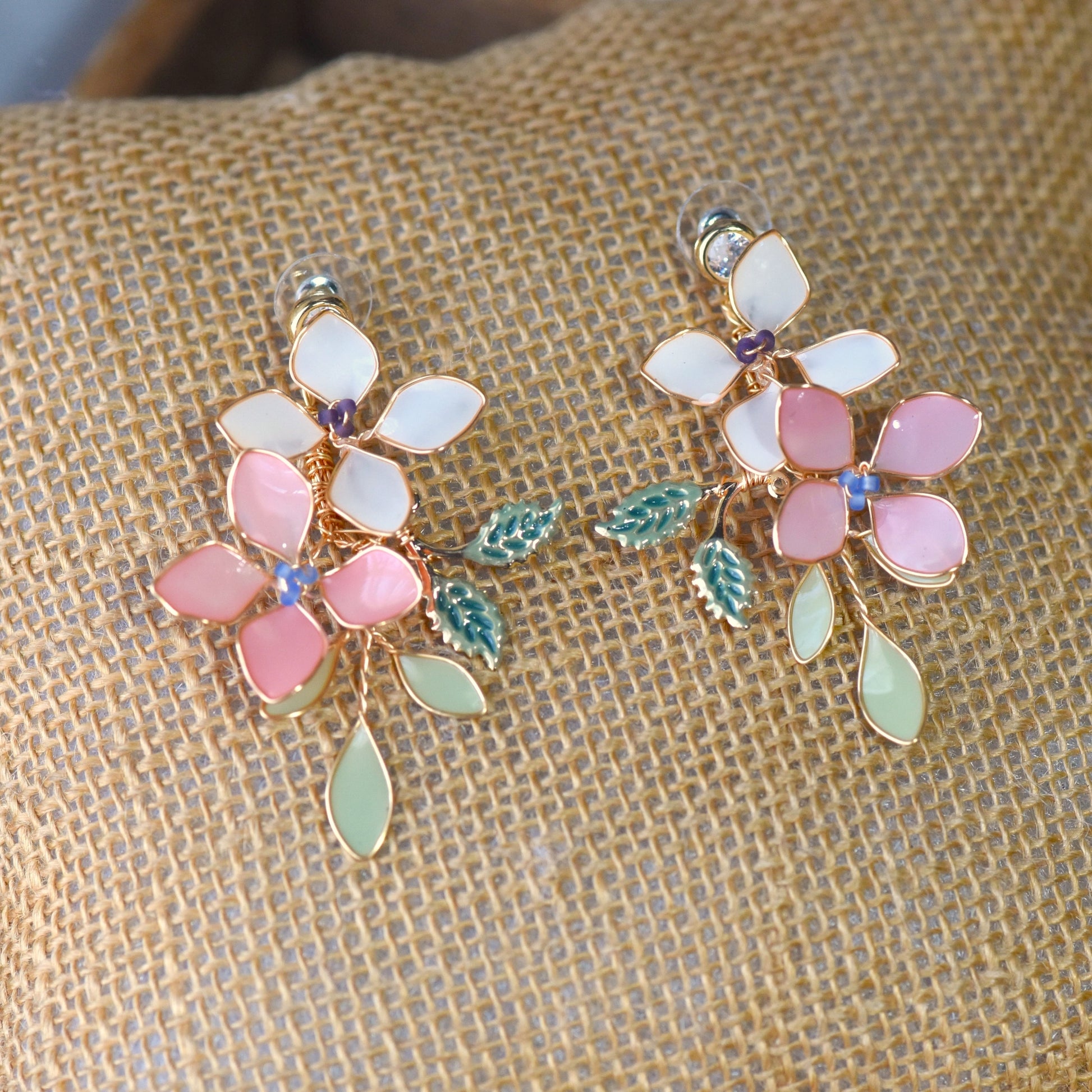 Candace handcrafted floral resin earrings featuring blush pink and ivory flowers with pastel green leaves and soft gold wire detailing