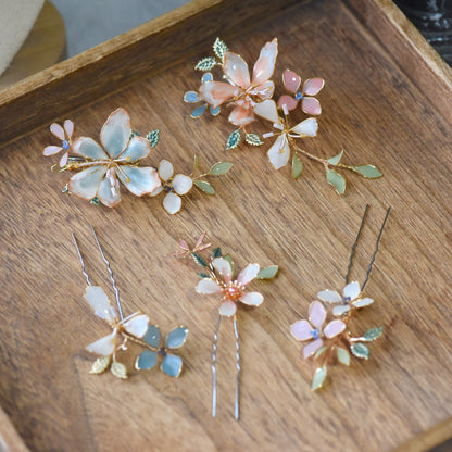 Close-up view of Candace floral hair clips showcasing handcrafted resin flowers, pastel petals and delicate gold wirework