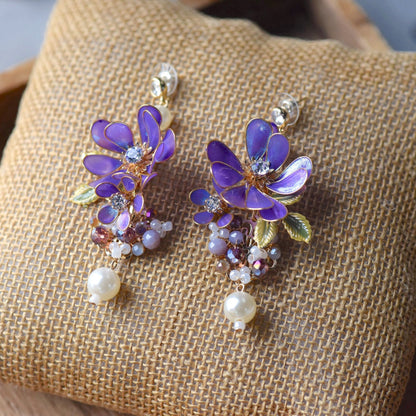 Capri handcrafted violet cobalt blue resin floral drop earrings crystal centre pearl drops mauve bead clusters flat lay burlap
