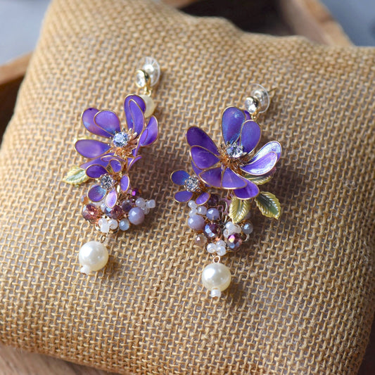 Capri handcrafted violet cobalt blue resin floral drop earrings crystal centre pearl drops mauve bead clusters flat lay burlap
