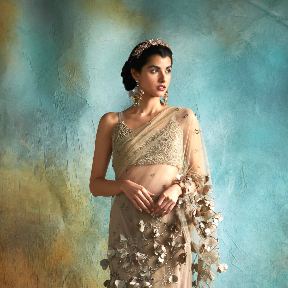 Model in a saree wearing Catriona lavender and green resin floral earrings
