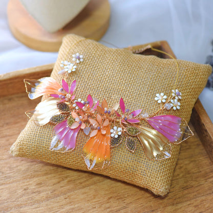 Catriona handcrafted resin floral necklace pink orange gold white daisy flat lay burlap cushion
