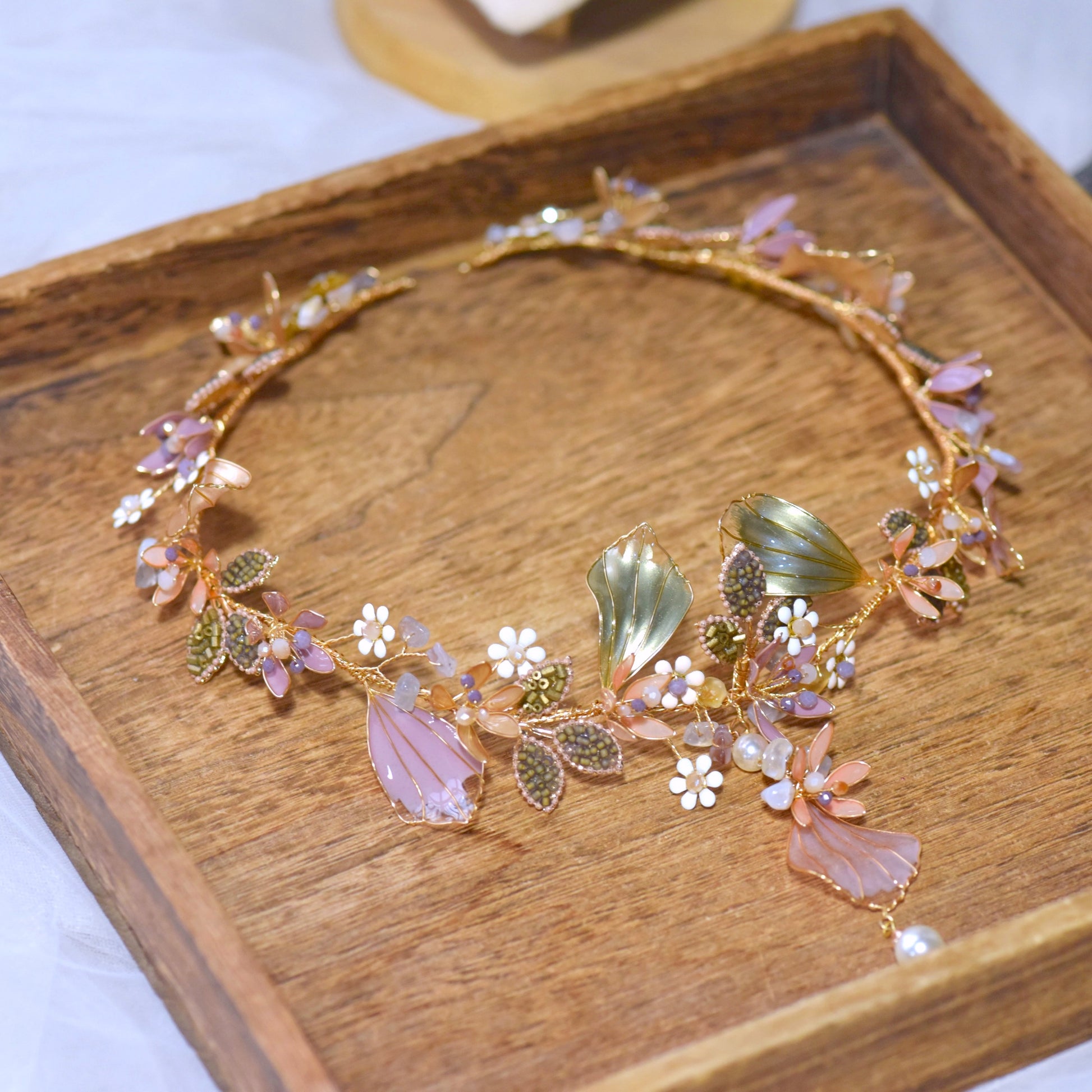 Catriona lavender and green resin floral head harness laid flat on a gold tray showing the full vine
