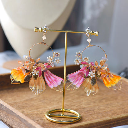 Catriona handcrafted resin floral earrings pink orange gold from jewellery set on stand
