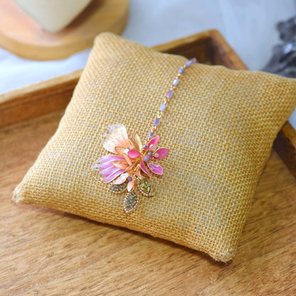 Catriona handcrafted resin floral maang tika pink orange gold from jewellery set flat lay burlap
