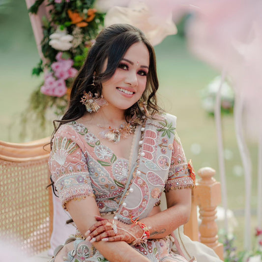 Real bride wearing the Catriona lavender and green resin floral necklace with matching earrings at her wedding celebration
