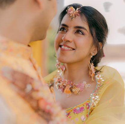 Bride wearing Catriona handcrafted resin floral maang tika earrings and necklace pink orange gold haldi yellow lehenga
