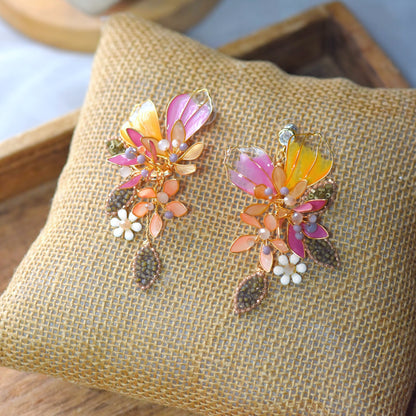Handcrafted botanical earrings with pink and orange resin petals and gold wire detailing