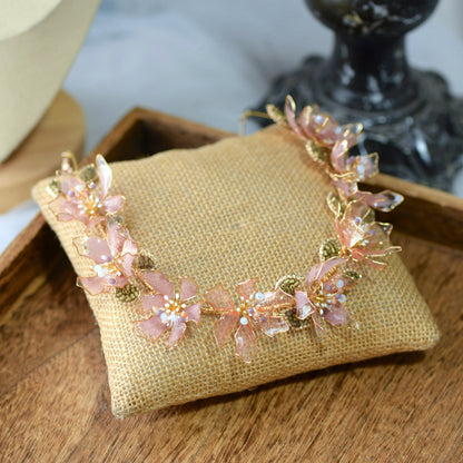 Celestina handcrafted resin floral necklace pink gold flat lay burlap cushion delicate botanical
