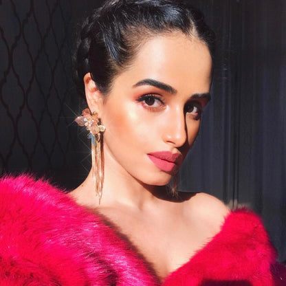 Model wearing Celestina handcrafted resin floral drop earrings pink gold with red outfit bridal styling
