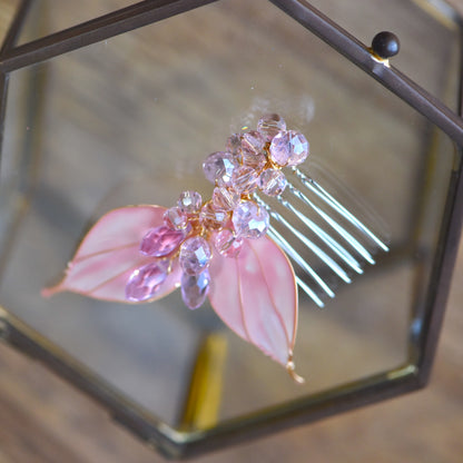 Close-up of Celine floral hair clips showing translucent pink resin leaves, faceted crystal beads and handcrafted gold wire finish