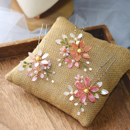Close view of Chloe blush resin floral hair clips showing petal and pearl detail
