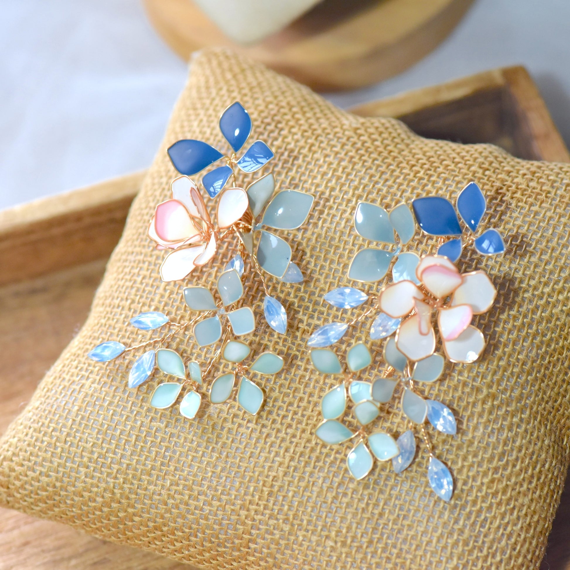 Ciel handcrafted blue botanical vine resin drop earrings cobalt navy powder blue mint grey blush pink bloom flat lay burlap
