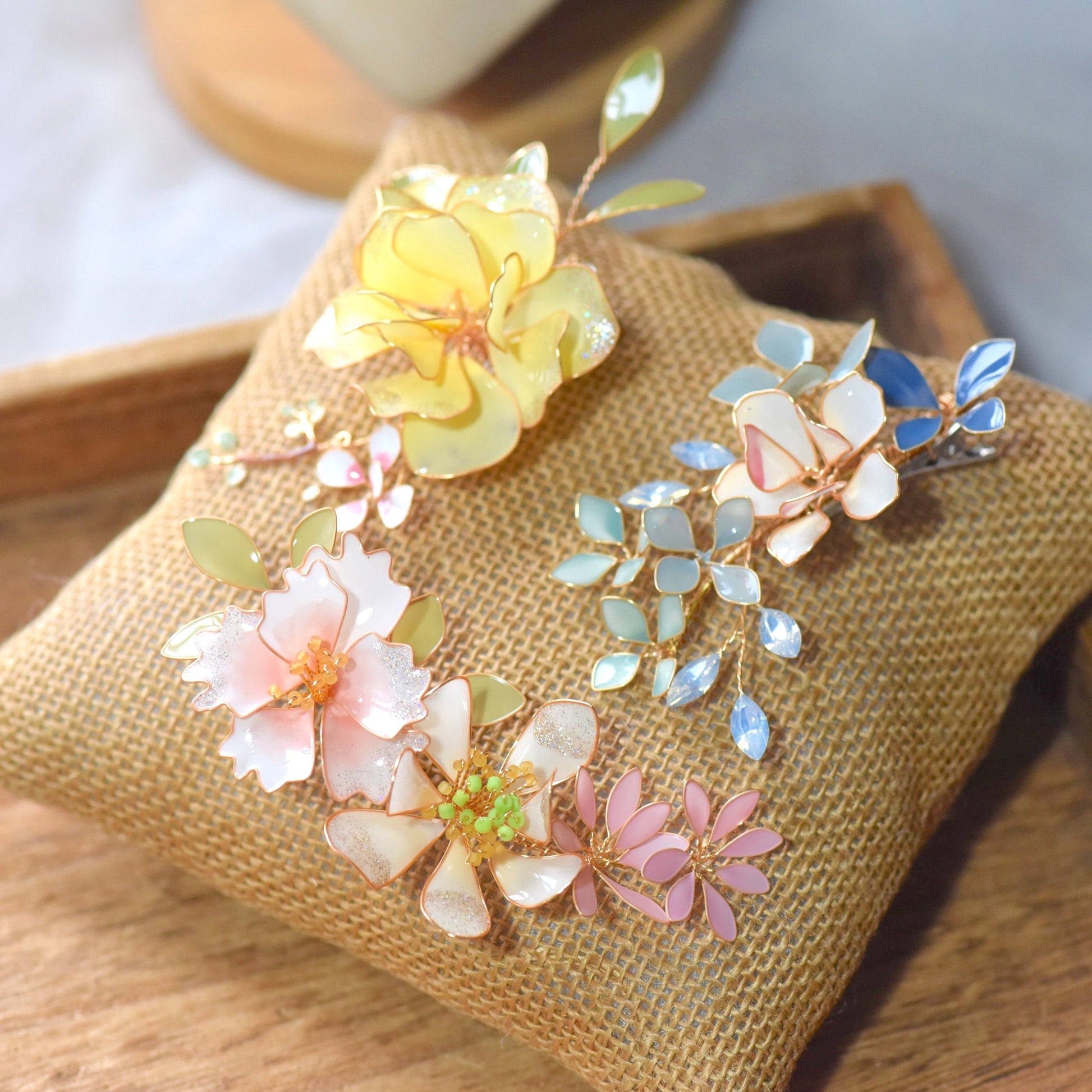 Elena handcrafted floral hair accessory with pastel resin flowers and gold wire detailing