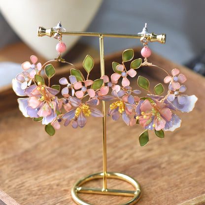 Ella blush pink and lavender resin floral earrings on a golden display stand