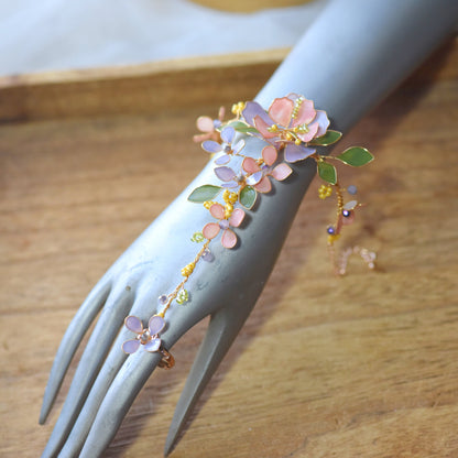 Ella blush pink and lavender resin floral hand harness shown on a mannequin hand with adjustable ring