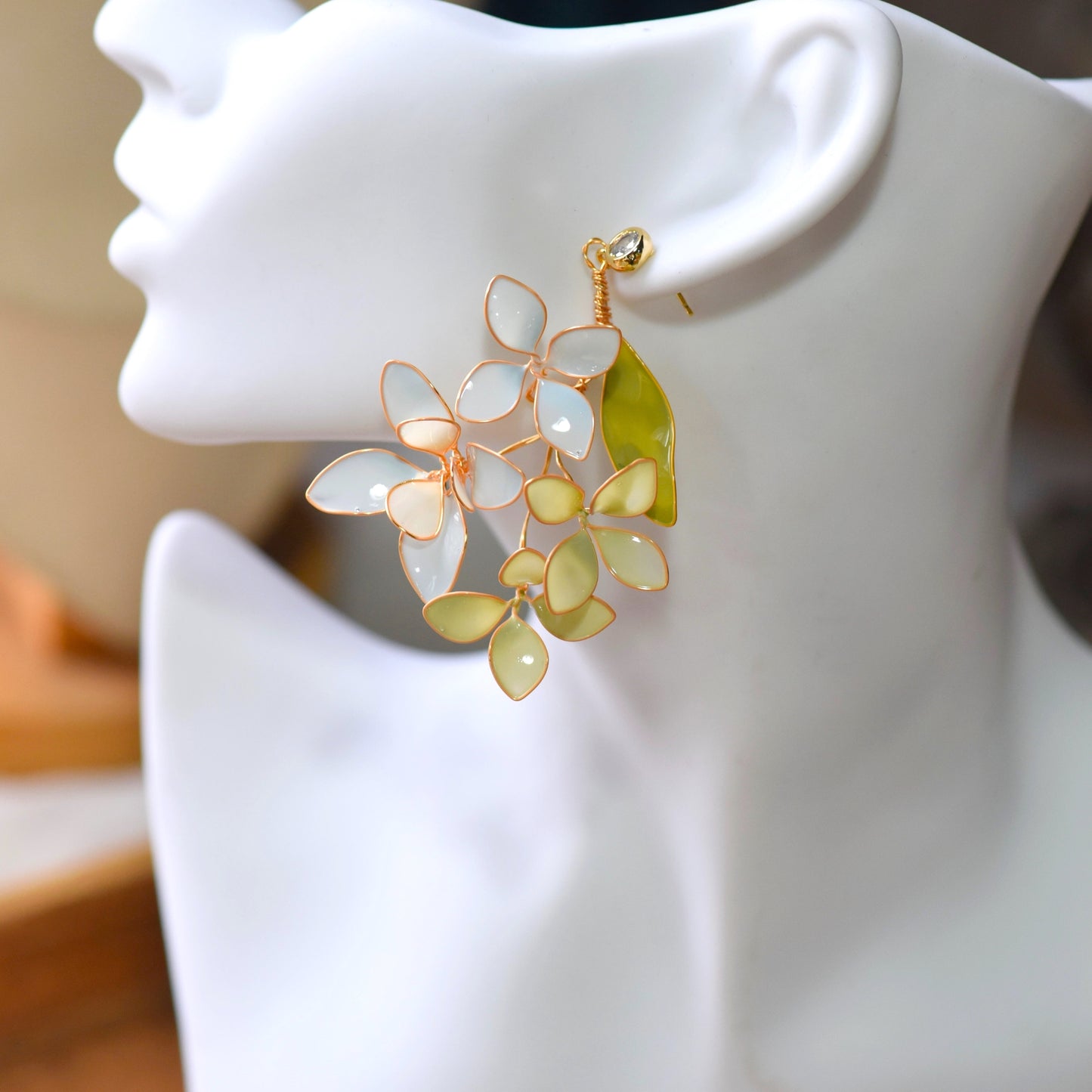 Close up of Fawn handcrafted floral earrings with mint and ivory petals