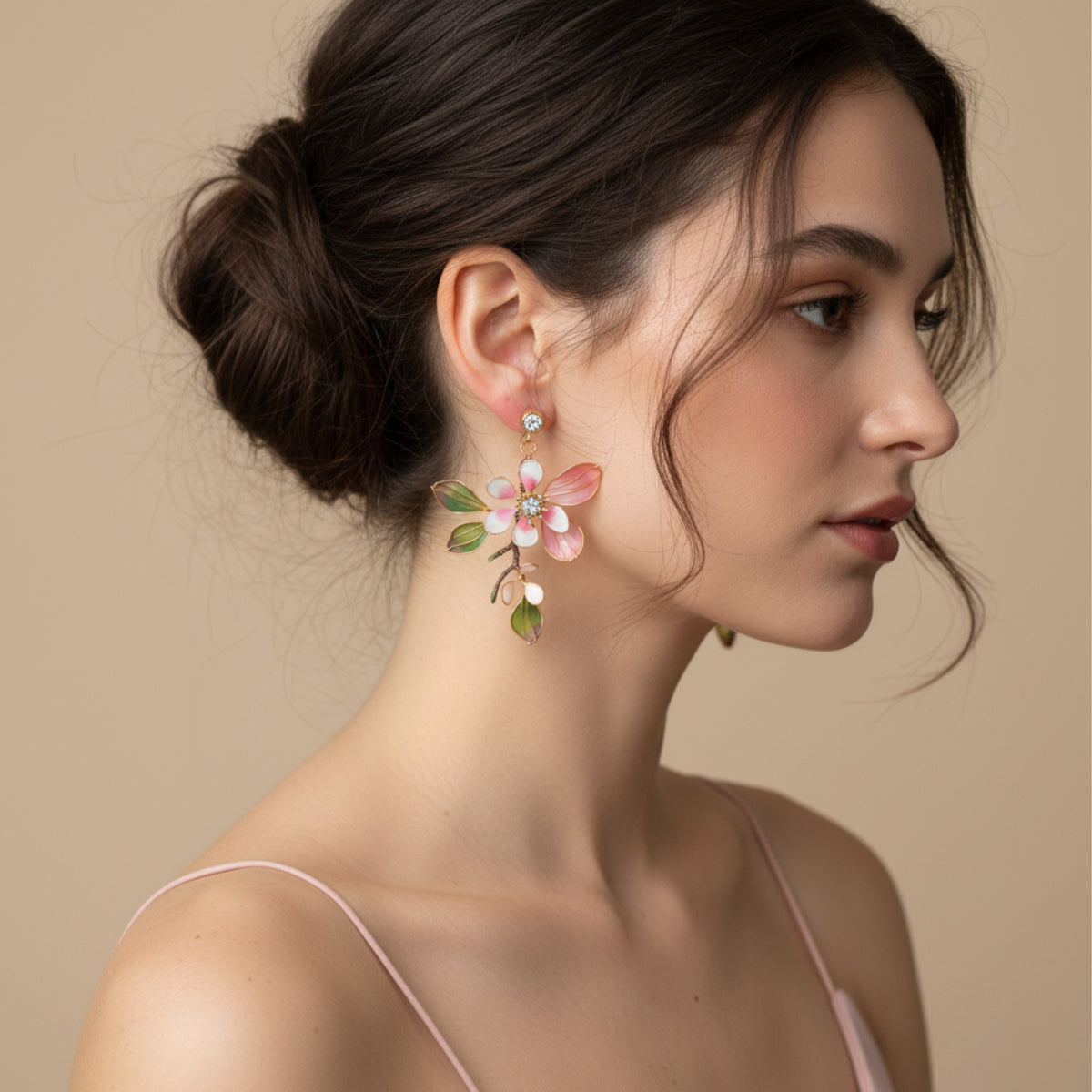 Model wearing Florentine blush pink resin floral earrings with hair in a low bun
