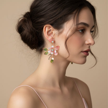 Model wearing Florentine blush pink resin floral earrings with hair in a low bun
