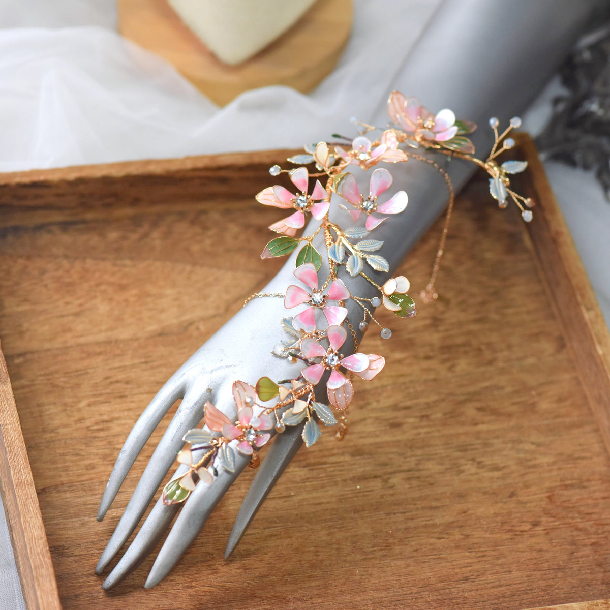 Florentine long blush pink floral haath phool on a display hand showing the full wrist-to-finger cascade
