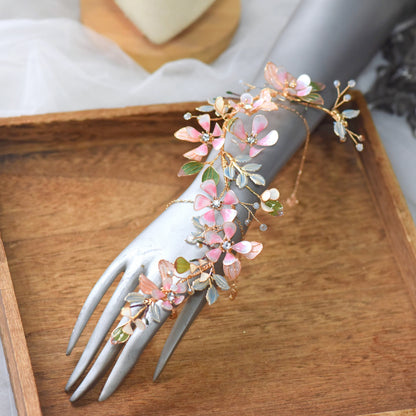 Florentine long blush pink floral haath phool on a display hand showing the full wrist-to-finger cascade
