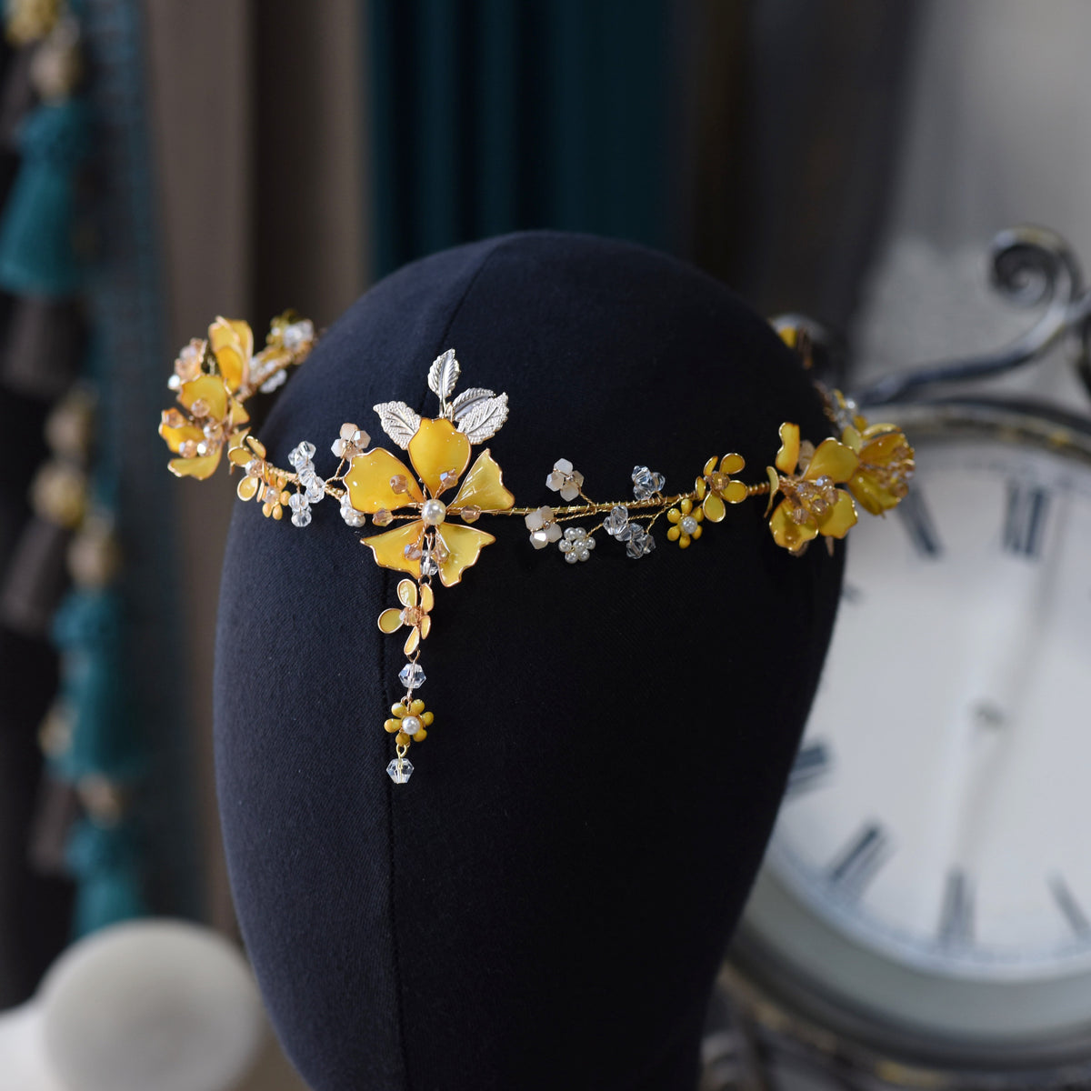 Close view of the Helios head harness showing the yellow blooms strung along a delicate golden vine
