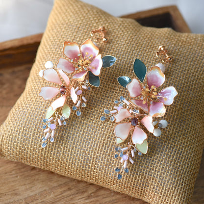 Imogen handcrafted blush pink resin floral drop earrings watercolour gradient crystal pale blue grey bead clusters flat lay burlap
