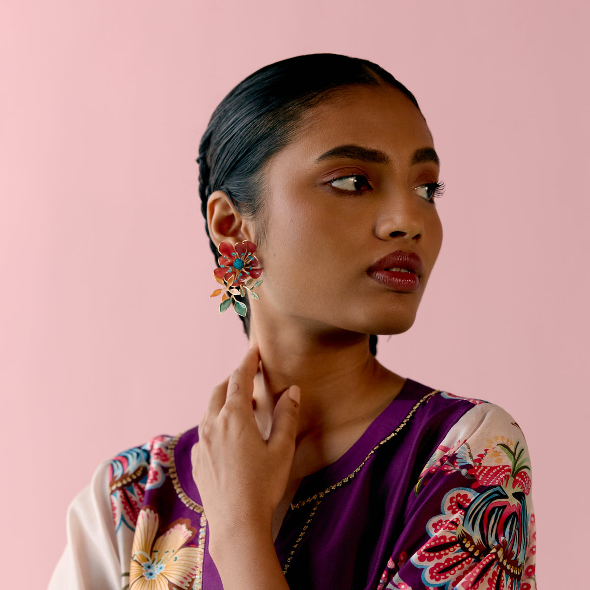 Isariah red and green resin floral stud earrings worn with a purple and ivory floral saree
