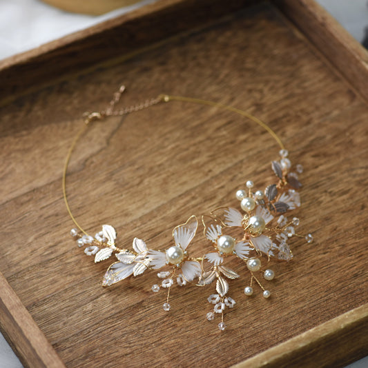 Juliana white resin floral necklace with imitation pearls and gold accents on display
