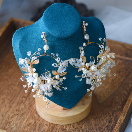 Juliana white and pearl resin floral earrings displayed on bust
