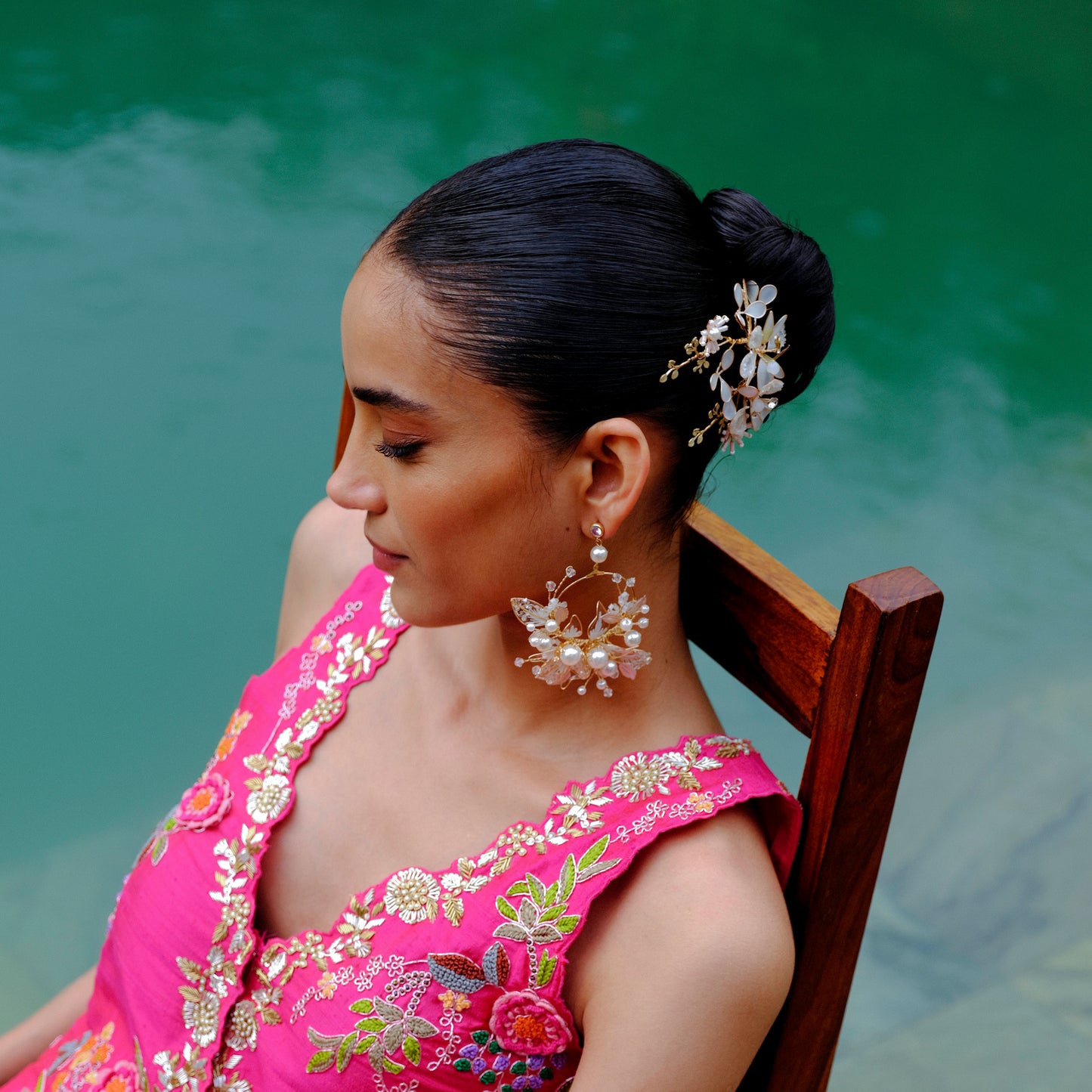 Model wearing Juliana white resin floral bridal earrings with pearl detail
