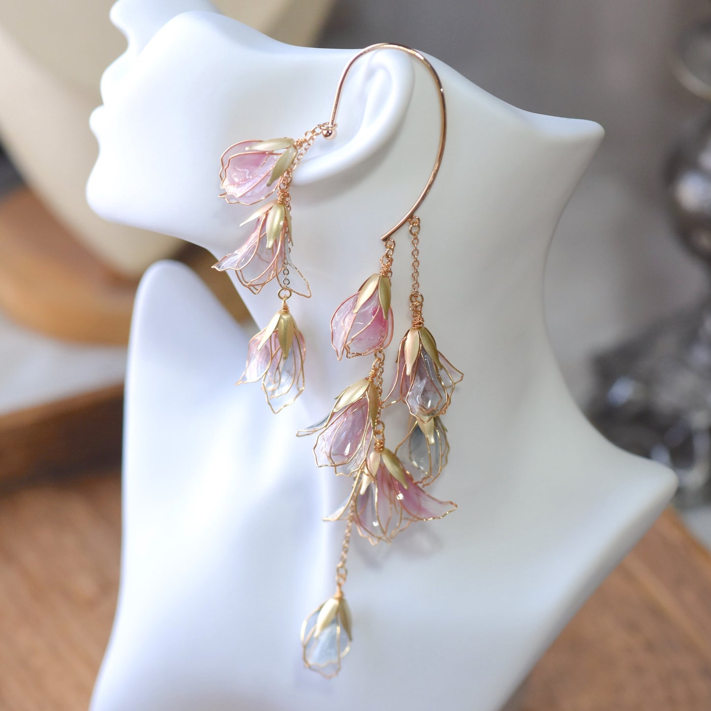 Side view of Julieta ear cuff showcasing cascading resin petals and delicate chain detailing