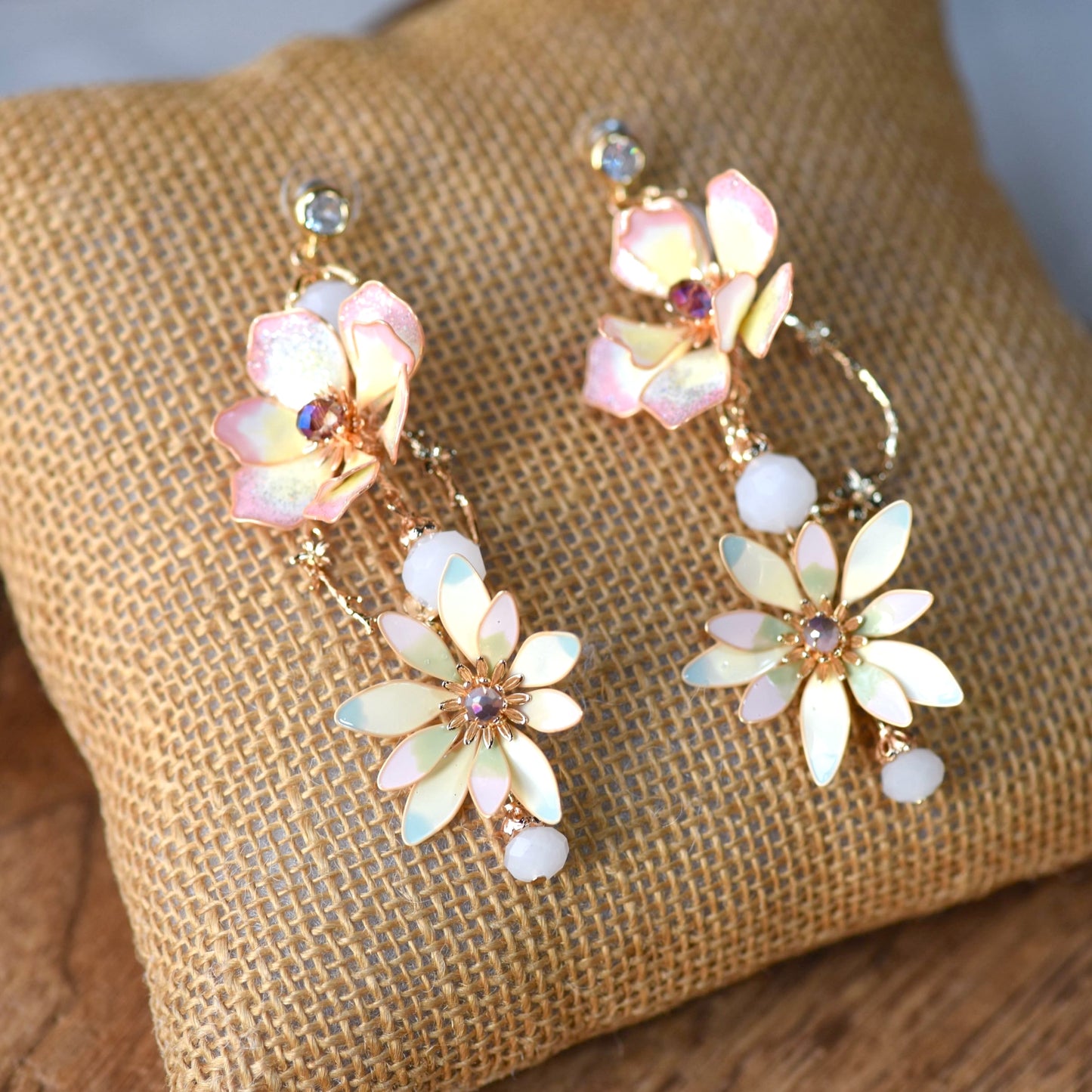 Liliana pink and yellow resin floral drop earrings on jute cushion
