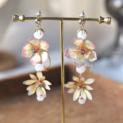 Liliana pink and yellow resin floral drop earrings on gold display stand
