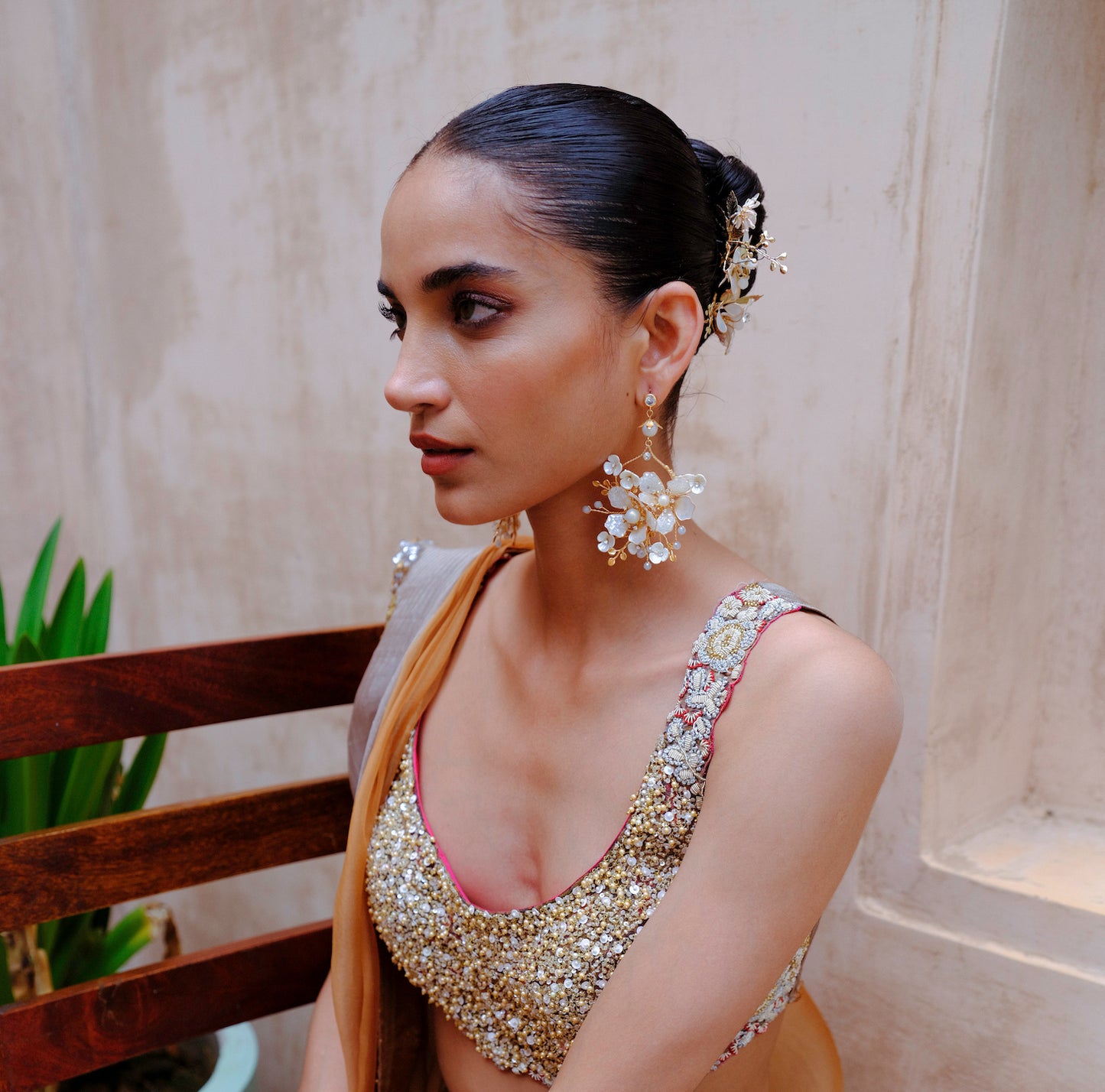 Model wearing Lorelle white resin floral earrings full look gold lehenga bridal styling The Vintage Snob