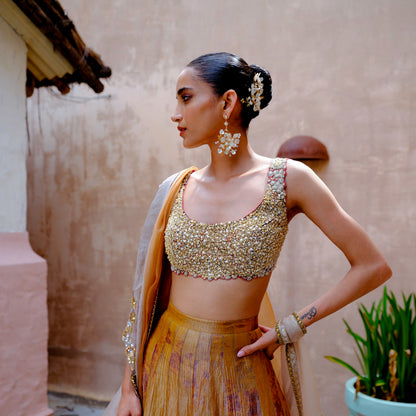 Model wearing Lorelle handcrafted white resin floral earrings with gold lehenga wedding look