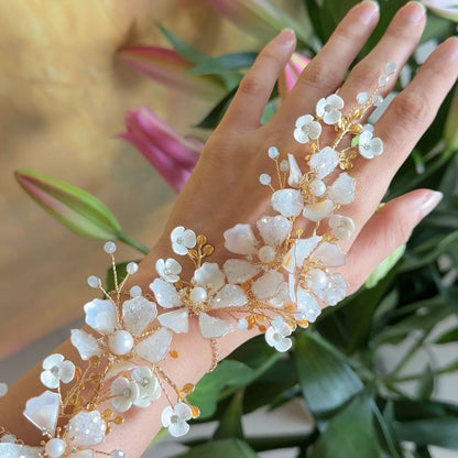 Model wearing Lorelle handcrafted white resin floral haath phool hand harness rose gold bridal look