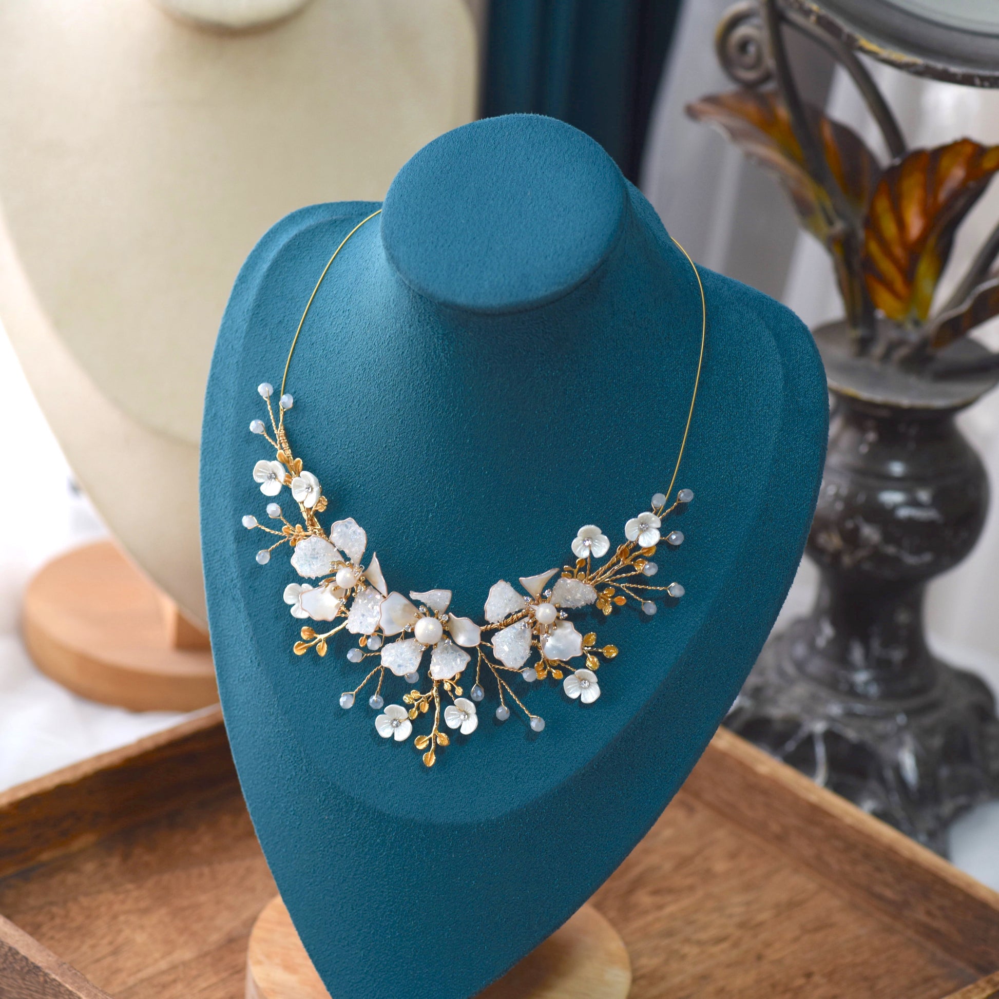 Lorelle handcrafted white resin floral necklace rose gold hints on teal bust botanical jewellery