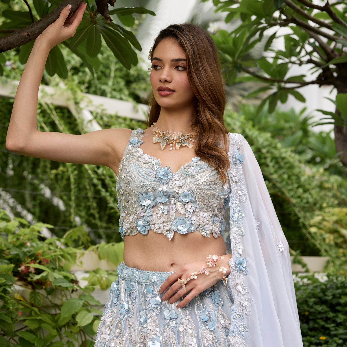 Model wearing Madeline pink and lavender resin floral haath phool in bridal look
