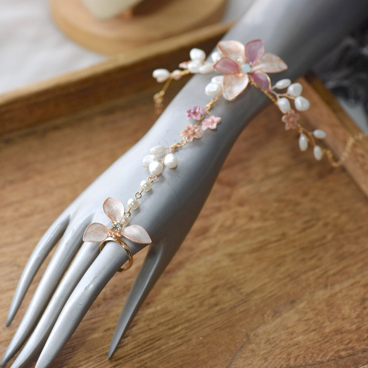 Madeline pink white and lavender resin floral haath phool worn on hand
