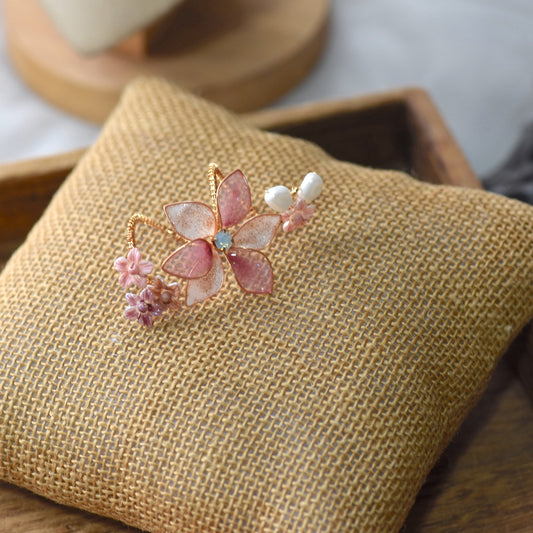 Madeline pink and lavender resin floral ring on jute cushion
