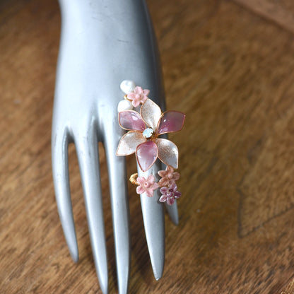 Madeline pink white and lavender resin floral adjustable ring worn on hand
