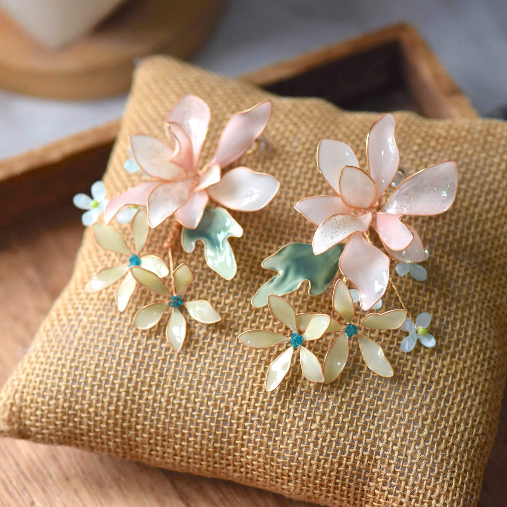 Margot handcrafted blush pink ivory resin floral drop earrings sage green teal crystal daisy rose gold wire flat lay burlap
