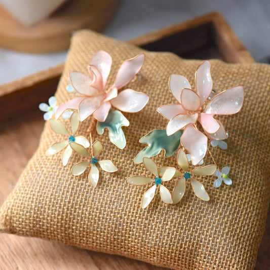 Margot handcrafted blush pink ivory resin floral drop earrings sage green teal crystal daisy rose gold wire flat lay burlap

