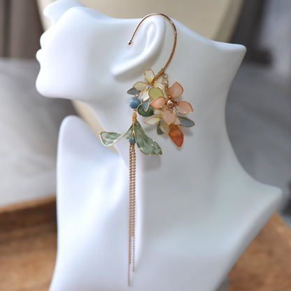 Mehr peach and sky blue resin floral ear cuff detail showing teal leaf drops and chain tassel
