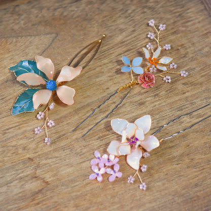 Close up of Micaela floral hair pin with pastel resin petals and gold wirework