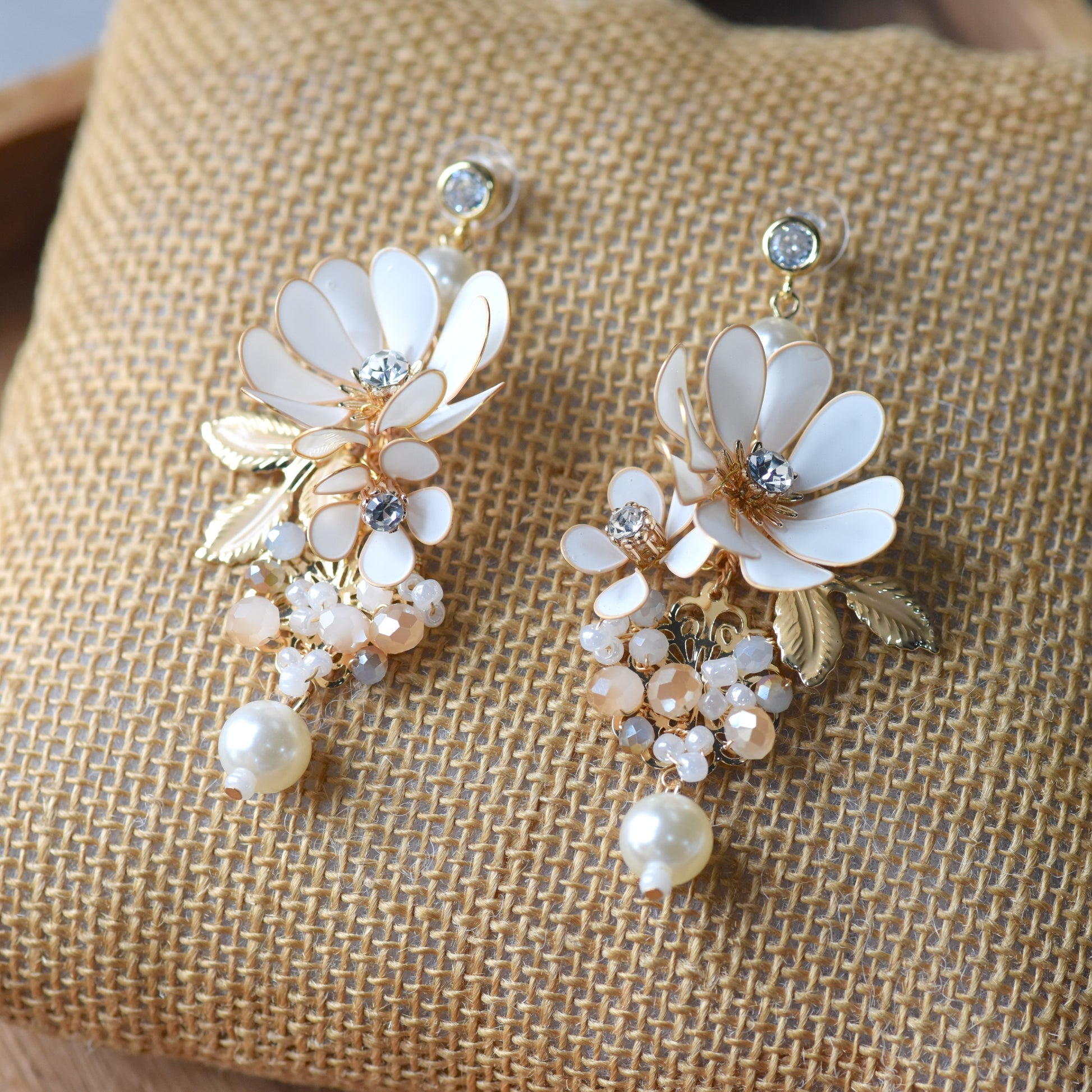 Odette handcrafted white ivory resin floral drop earrings pearl crystal champagne bead clusters gold flat lay burlap
